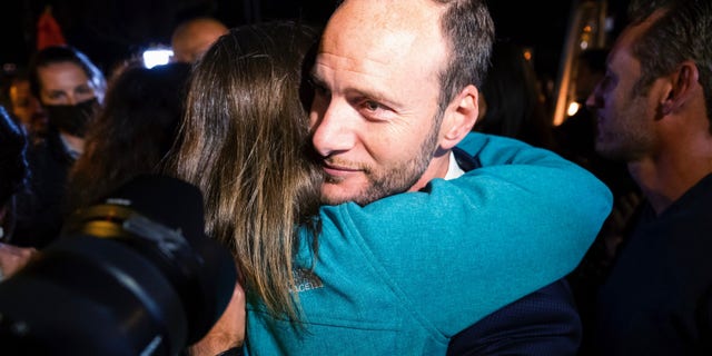 San Francisco District Attorney Chesa Boudin hugs a supporter Tuesday, June 7, 2022, in San Francisco. (AP Photo/Noah Berger)