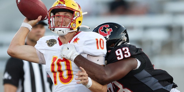 Case Cookus (10) of the Philadelphia Stars is tackled by Chris Odom (93) of the Houston Gamblers in the third quarter of a game at Protective Stadium May 29, 2022, in Birmingham, Ala.