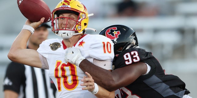 Case Cookus (10) of the Philadelphia Stars is tackled by Chris Odom (93) of the Houston Gamblers in the third quarter of a game at Protective Stadium May 29, 2022, in Birmingham, Ala.