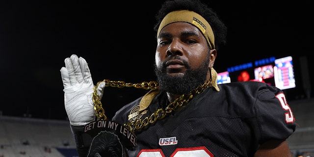 Chris Odom of the Houston Gamblers shows off his necklace in the third quarter of a game against the New Orleans Breakers at Legion Field June 19, 2022, in Birmingham, Ala.