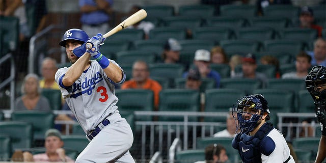 Los Angeles Dodgers' Chris Taylor hits an RBI double, scoring his team's first run during the eleventh inning of a baseball game against the Atlanta Braves on Sunday, June 26, 2022, in Atlanta. The Dodgers won 5-3. 