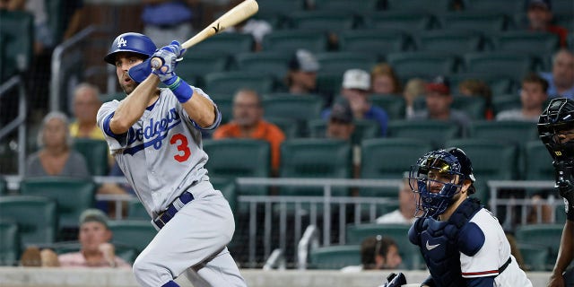 Los Angeles Dodgers' Chris Taylor hits an RBI double, scoring his team's first run during the eleventh inning of a baseball game against the Atlanta Braves on Sunday, June 26, 2022, in Atlanta. The Dodgers won 5-3.