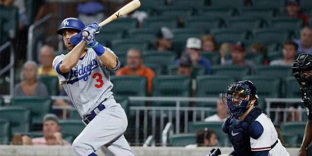 Los Angeles Dodgers' Chris Taylor hits an RBI double, scoring his team's first run during the eleventh inning of a baseball game against the Atlanta Braves on Sunday, June 26, 2022, in Atlanta. The Dodgers won 5-3. 