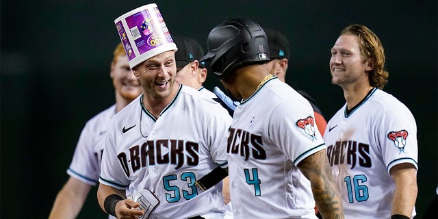 Arizona Diamondbacks' Christian Walker (53) celebrates with Ketel Marte (4) and Jake Hager (16) after Walker grounder on which Josh Rojas scored the winning run against the San Diego Padres during the ninth inning of a baseball game Tuesday, June 28, 2022, in Phoenix. The Diamondbacks won 7-6.