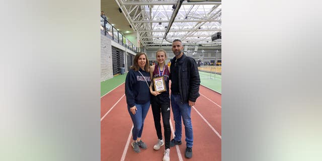Doug, Christy, and Chelsea Mitchell, taken at the NCCC Indoor Track Championship, New Haven, Conn. on Feb 1, 2020 (senior year). Chelsea's team won the conference championship, and she had three gold medals in the 55m, 300m, and long jump.