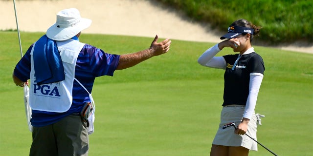 In Gee Chun, of South Korea, wipes her eyes as she prepares for her caddy's hug after winning the KPMG Women's PGA Championship golf tournament at Congressional Country Club, Sunday, June 26, 2022, in Bethesda, Md.