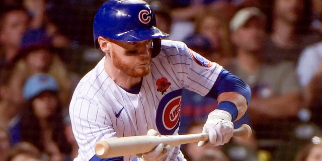 The Chicago Cubs' Clint Frazier bunts against the Milwaukee Brewers May 30, 2022, at Wrigley Field in Chicago. 
