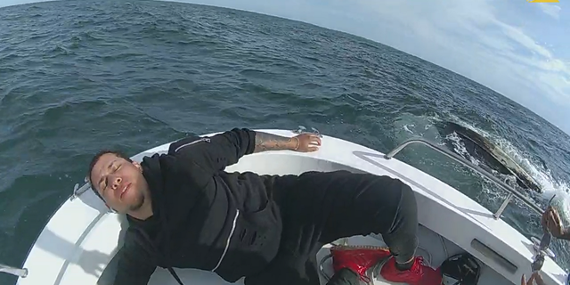One of the boaters appears relieved after being brought to safety.