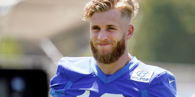 Los Angeles Rams wide receiver Cooper Kupp smiles during stretching at the team's practice facility May 26, 2022, in Thousand Oaks, Calif.