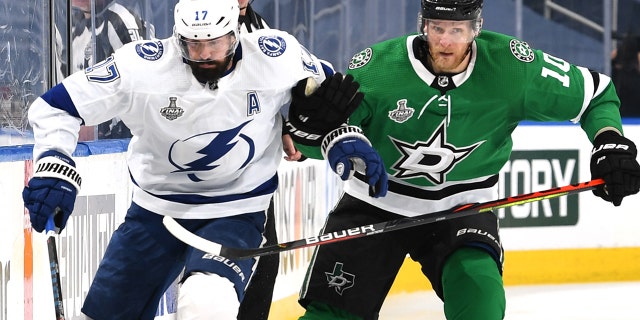 Alex Killorn #17 of the Tampa Bay Lightning skates with the puck through the neutral zone as Corey Perry #10 of the Dallas Stars pursues the play in the second period of Game Six of the NHL Stanley Cup Final between the Tampa Bay Lightning and the Dallas Stars at Rogers Place on September 28, 2020 in Edmonton, Alberta, Canada.