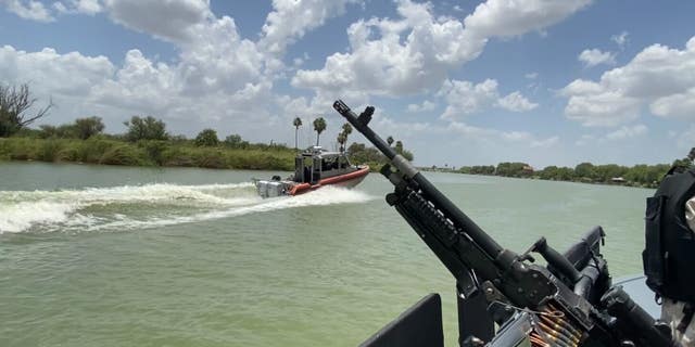 In an image taken from a Texas Department of Public Safety boat, a U.S. Coast Guard vessel patrols the Rio Grande. 