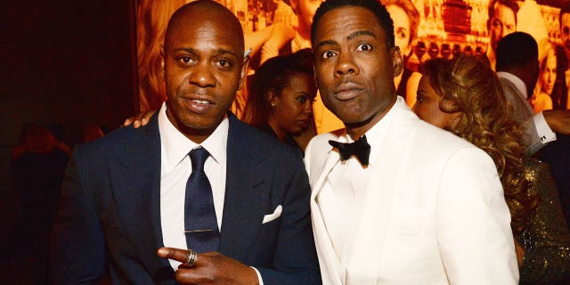 Lee said he was "inspired" by Will Smith's 2022 Oscars slap of comedian Chris Rock. Rock is pictured here with Chappelle. 