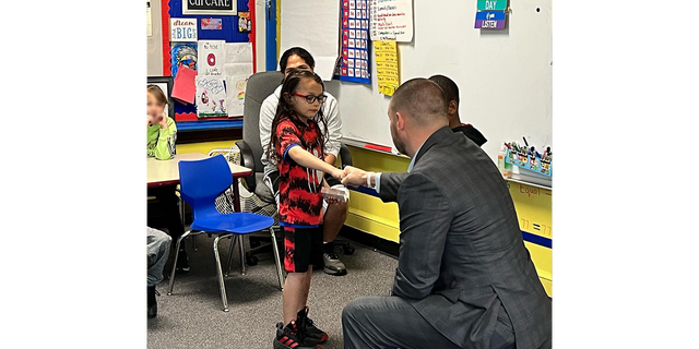 David Diaz Jr., a Woodrow Wilson Elementary School local hero, and N.Y. State Sen. Fred Akshar shake hands as the 7-year-old is honored during a June award ceremony.