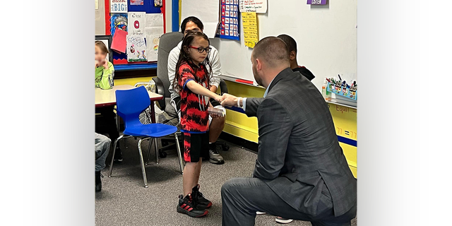 David Diaz Jr., a Woodrow Wilson Elementary School local hero, and N.Y. State Sen. Fred Akshar shake hands as the 7-year-old is honored during a June award ceremony.