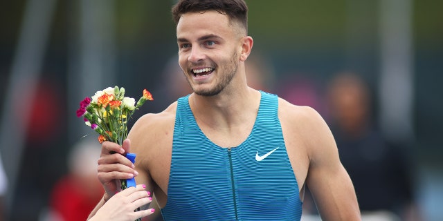 Devon Allen celebrates after winning the men's 110m hurdle during the New York Grand Prix at Icahn Stadium on June 12, 2022.
