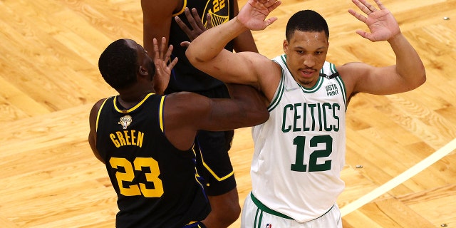 Grant Williams (12) of the Boston Celtics and Draymond Green (23) of the Golden State Warriors argue in the second quarter during Game 3 of the 2022 NBA Finals at TD Garden in Boston June 8, 2022.