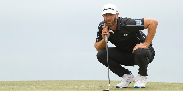 Dustin Johnson lines up his putt during the U.S. Open at Torrey Pines Golf Course on June 20, 2021, in San Diego,