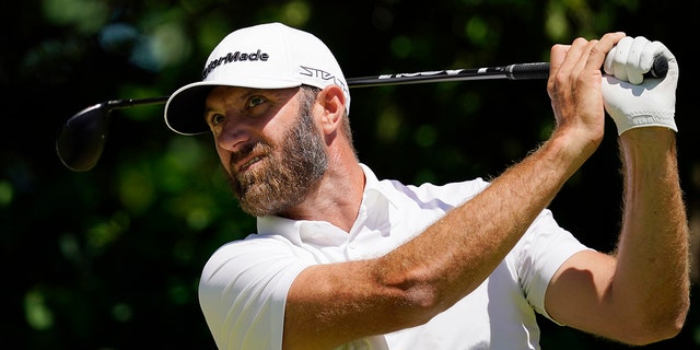 Dustin Johnson hits on the seventh hole during a practice round for the U.S. Open golf tournament at The Country Club, Wednesday, June 15, 2022, in Brookline, Mass. 