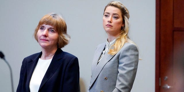 Actor Amber Heard stands with attorney Elaine Bredehoft before closing arguments in the Depp v. Heard trial at the Fairfax County Circuit Courthouse in Fairfax, Virginia, on May 27, 2022.