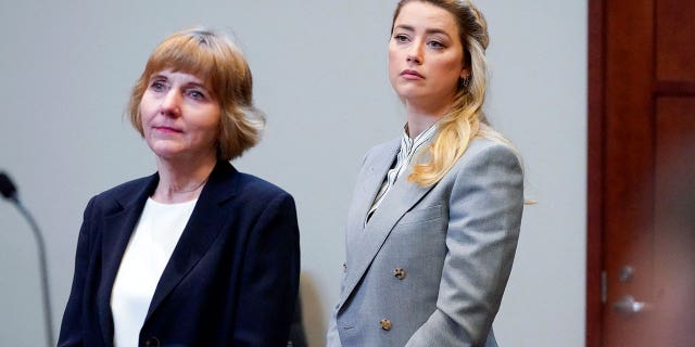 Amber Heard stands with her attorney, Elaine Bredehoft, before closing arguments at the Fairfax County Circuit Courthouse on May 27, 2022.