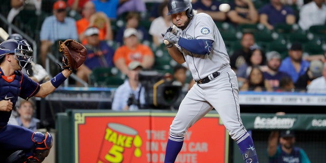Seattle Mariners batter Eugenio Suarez ducks a pitch near his head from Houston Astros relief pitcher Hector Neris during the ninth inning of a baseball game Monday, June 6, 2022, in Houston. Neris was ejected from the game for the pitch which happened on the next batter after Neris hit Seattle Mariners' Ty France, causing both dugouts to empty with ejections on both teams.