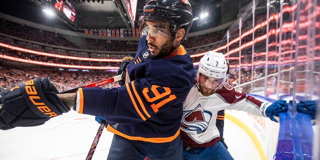Colorado Avalanche' Devon Toews (7) and Edmonton Oilers' Evander Kane (91) battle on the corner during the second period of Game 3 of the NHL hockey Stanley Cup playoffs Western Conference finals, Saturday, June 4, 2022, in Edmonton, Alberta.