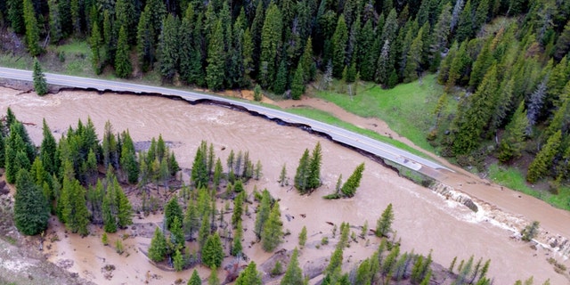 This aerial photo provided by the National Park Service shows a flooded out North Entrance Road, of Yellowstone National Park in Gardiner, Mont., on June 13, 2022. 