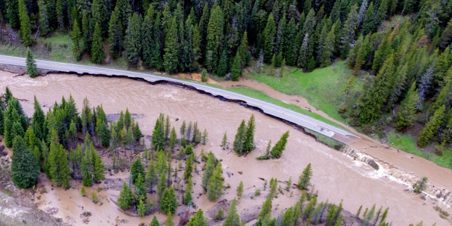 This aerial photo provided by the National Park Service shows a flooded out North Entrance Road, of Yellowstone National Park in Gardiner, Mont., on June 13, 2022. 