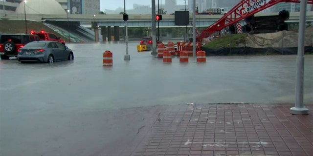 Vehicles drive through flooded streets in Miami, as a tropical depression swept across South Florida, Saturday, June 4, 2022.