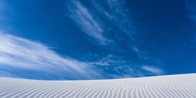 Ripple patterns and blue sky in White Sands National Park, New Mexico.