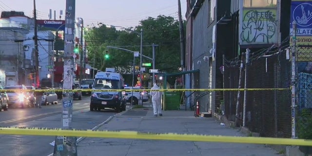Police tape blocks a murder scene where a man was shot and killed while leaving a New York City recording studio.