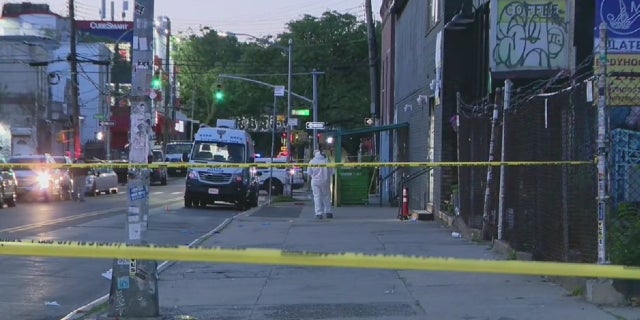 Police tape blocks a murder scene where a man was shot and killed while leaving a New York City recording studio.