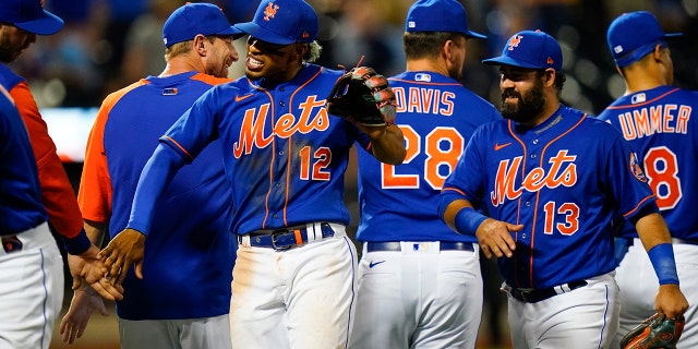 New York Mets' Francisco Lindor (12) and Luis Guillorme (13) celebrate with teammates after a 4-0 win over the Milwaukee Brewers in a baseball game Tuesday, June 14, 2022, in New York. 