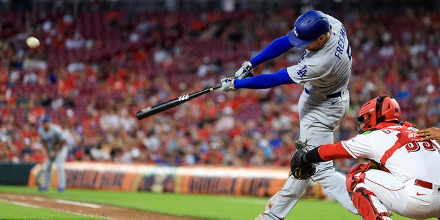 Los Angeles Dodgers' Freddie Freeman hits a three-run triple during the eighth inning of a baseball game against the Cincinnati Reds in Cincinnati, Tuesday, June 21, 2022. The Dodgers won 8-2.