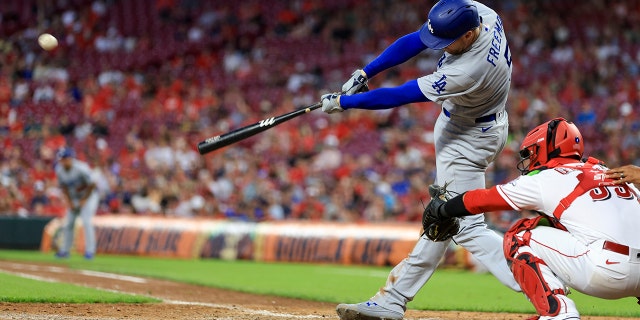 Los Angeles Dodgers' Freddie Freeman hits a three-run triple during the eighth inning of a baseball game against the Cincinnati Reds in Cincinnati, Tuesday, June 21, 2022. The Dodgers won 8-2.