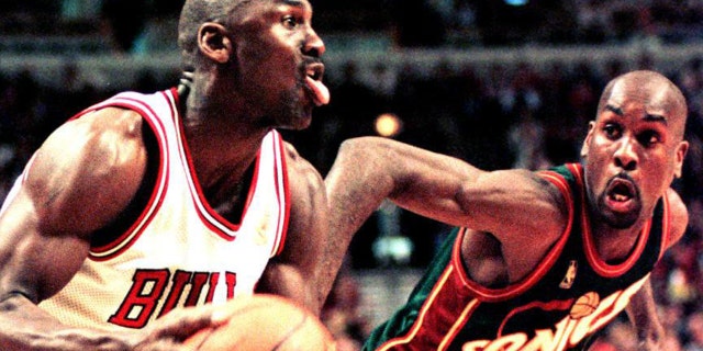 Michael Jordan of the Chicago Bulls looks to make a basket as Seattle SuperSonics guard Gary Payton defends in the fourth quarter of the 18 March game at the United Center in Chicago, Illinois.