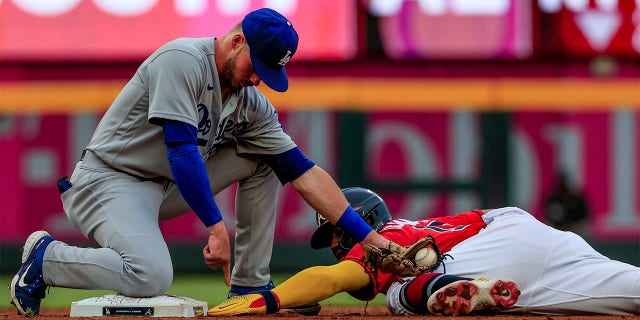 Atlanta Braves' Ronald Acuna Jr., right, is tagged out by Los Angeles Dodgers second baseman Gavin Lux, left, as he slides into second during the first inning of a baseball game Friday, June 24, 2022, in Atlanta.