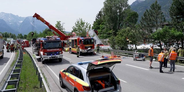 This video grab shows firemen and rescue helpers working next to a derailed train on June 3, 2022, in Burgrain near Garmisch-Partenkirchen, southern Germany. 