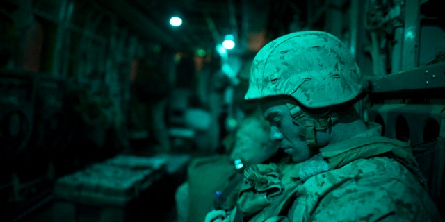 A U.S. Marine from the 1st Battalion, 8th Marines, sleeps in a helicopter during a flight to Musa Qala District Center base on Jan. 16, 2011. 