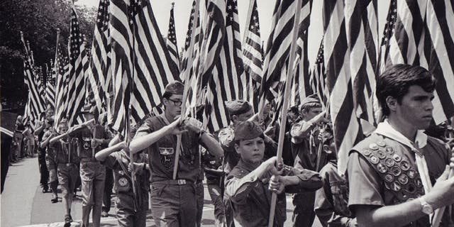 Boy Scouts carry American flags for the Fourth of July (AKA Honor America Day) in Washington, D.C., circa 1970.