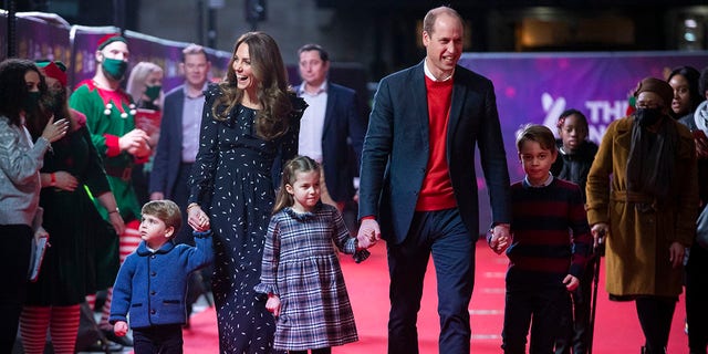 Prince William and Catherine, Duchess of Cambridge with their children, Prince Louis, Princess Charlotte and Prince George, attend a special performance at London's Palladium Theatre to thank workers and their families for their efforts throughout the pandemic on Dec. 11, 2020, in London.