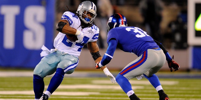 Dallas Cowboys running back Marion Barber (24) carries the ball as New York Giants cornerback Aaron Ross (31) defends during the second half of a game in East Rutherford, N.J., Nov. 14, 2010.