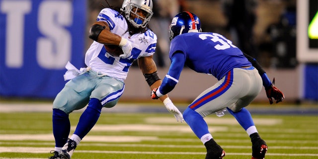 Dallas Cowboys running back Marion Barber (24) carries the ball as New York Giants cornerback Aaron Ross (31) defends during the second half of a game in East Rutherford, N.J., Nov. 14, 2010.
