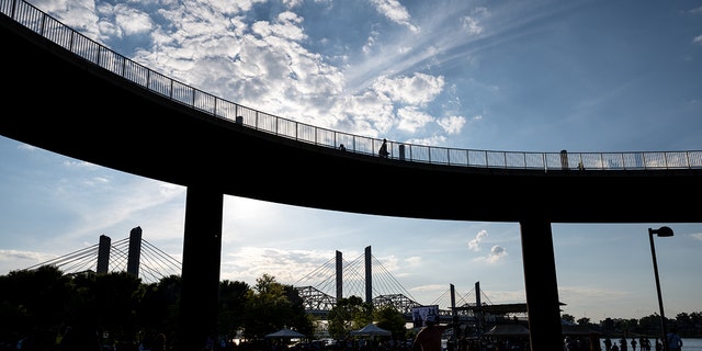 LOUISVILLE, KY - JUNE 05: People stand under the Big Four Bridge during the "Praise in the Park" event at the Big Four Lawn on June 5, 2021 in Louisville, Kentucky.  