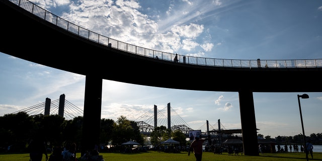 LOUISVILLE, KY - JUNE 05: People stand under the Big Four Bridge during the