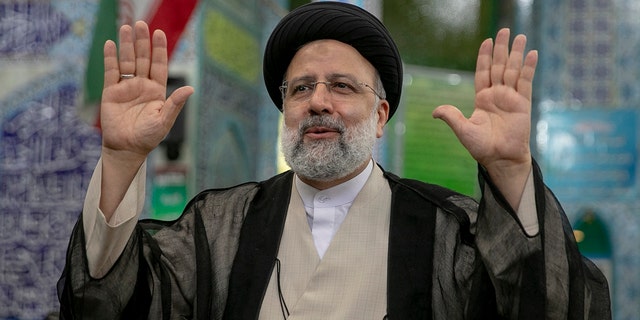 Ebrahim Raisi, a candidate in Iran's presidential elections waves to the media after casting his vote at a polling station in Tehran, Iran on June 18, 2021, on the day of the Islamic republic's presidential election.  The country's incumbent president, Hassan Rouhani, is ineligible to run again after serving two terms in office.