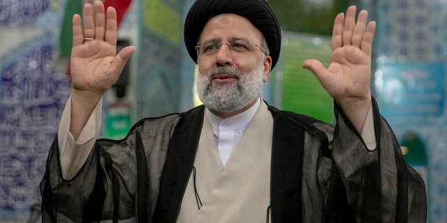 Ebrahim Raisi, a candidate in Iran's presidential elections waves to the media after casting his vote at a polling station in Tehran, Iran on June 18, 2021, on the day of the Islamic republic's presidential election.  The country's incumbent president, Hassan Rouhani, is ineligible to run again after serving two terms in office.