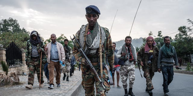 TOPSHOT - Tigray People's Liberation Front (TPLF) fighters arrive after eight hours of walking in Mekele, the capital of Tigray region, Ethiopia, on June 29, 2021.