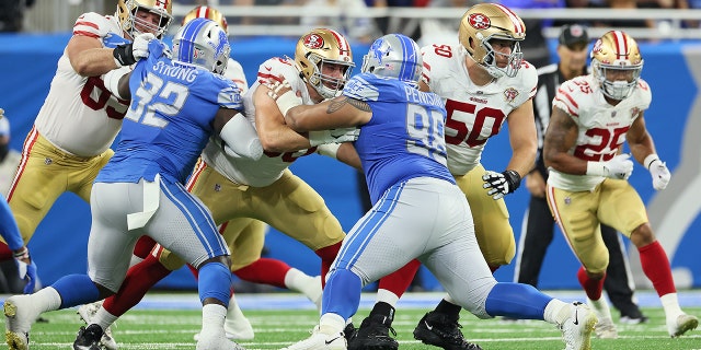 Detroit Lions defensive tackle John Penisini (98) holds the line against San Francisco 49ers offensive tackle Daniel Brunskill (60) during a game in Detroit Sept. 12, 2021.