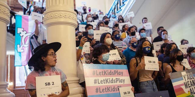 LGBTQ rights supporters gather at the Texas State Capitol to protest state Republican-led efforts to pass legislation that would restrict the participation of transgender student athletes on Sept. 20, 2021, in Austin, Texas.